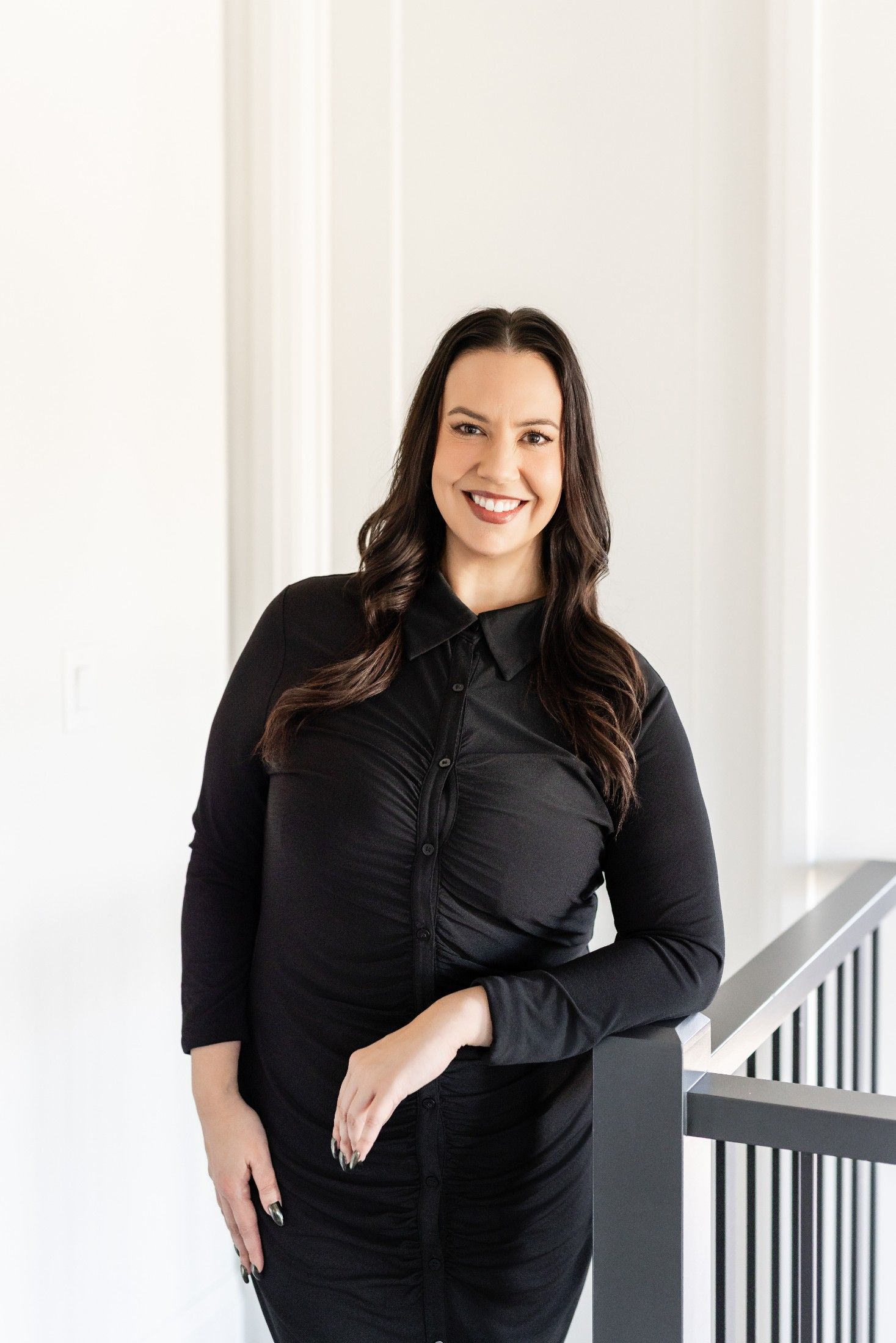 Yvonne Valdes, Edmonton real estate advisor, smiling in a bright modern home